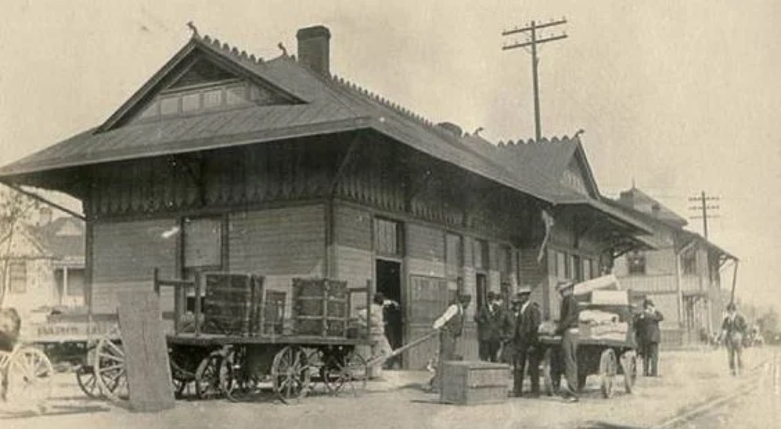 Historic photo of the Paris, Kentucky Train Depot in the early 1900s with horse-drawn wagons and passengers